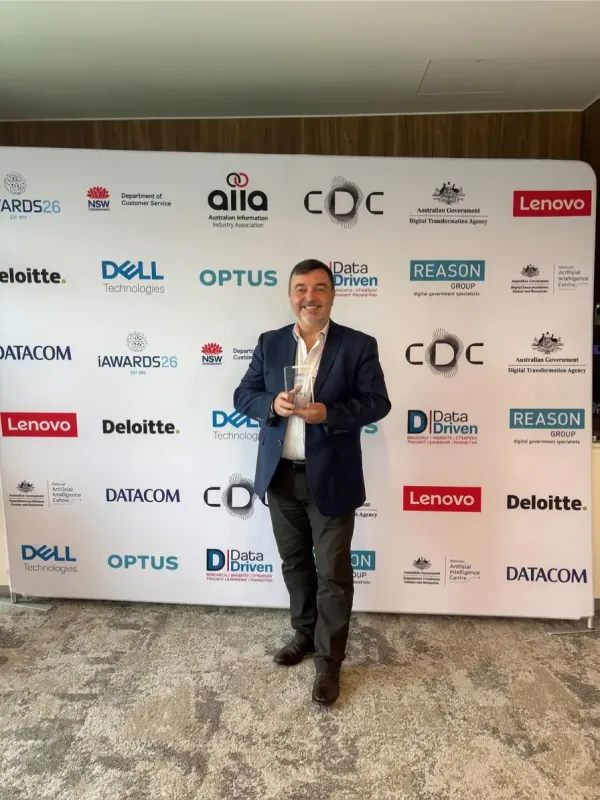 Keen Care representative holding the iAwards trophy